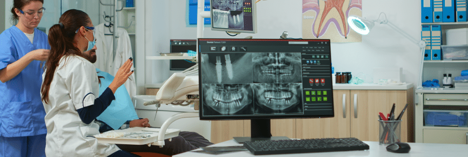 Dental professionals reviewing X-rays for pediatric pulp therapy treatment